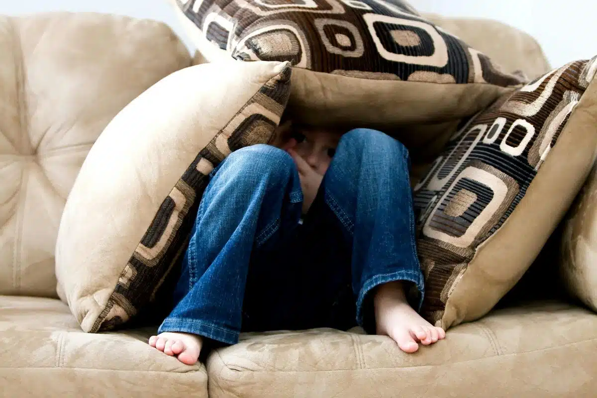 Enfant Se Cachant Sur Des Oreillers